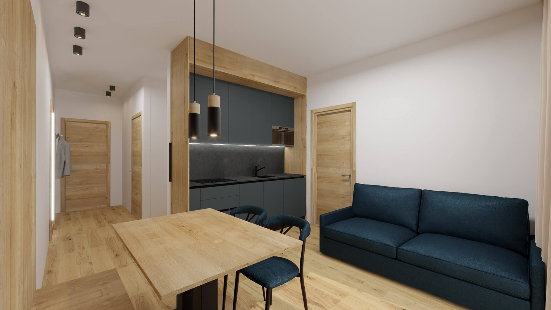 Wohnzimmer im Apartment 2 mit einem dunkelblauen Sofa, rechts eine dunkelgraue Kochnische und im Vordergrund ein Holztisch mit zwei Stühlen - sil132 apartments